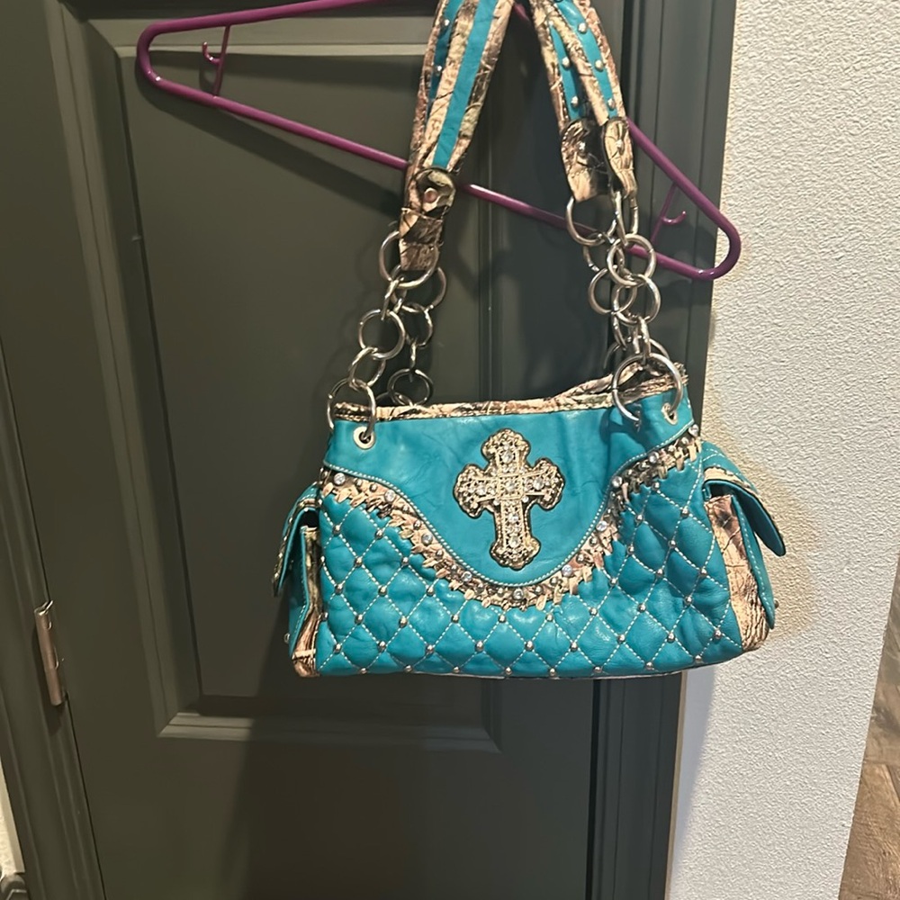 Blue purse with camouflage inside, used but still in good condition
